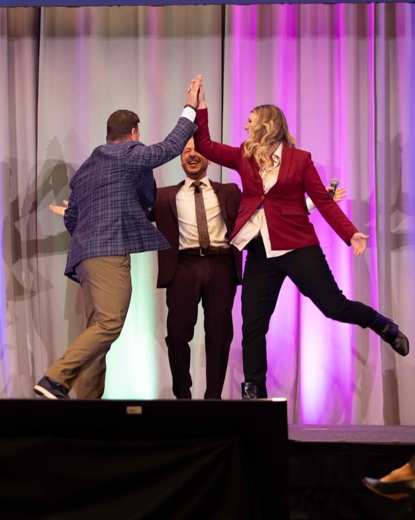 Mentalist and audience member celebrating on stage